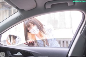 A woman sitting in the back seat of a car wearing stockings.