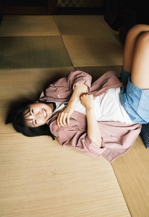 A woman sitting on a chair with her legs crossed.