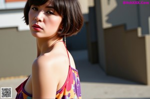 A woman in a colorful kimono sitting on the ground.