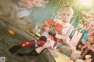 A woman in a kimono sitting on a wooden bench.