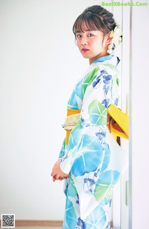 A woman in a kimono is posing for a picture.