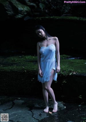 A japanese woman with long black hair is posing for the camera.