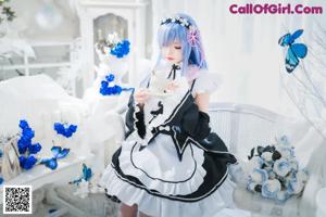 A woman in a maid outfit posing for a picture.