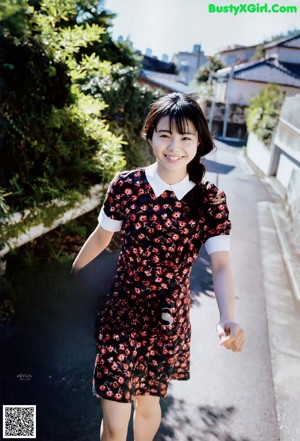 A woman in a white shirt is posing for a picture.