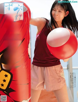 A woman in a yellow shirt is playing ping pong.