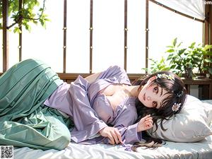 A woman in a kimono sitting on a window sill.