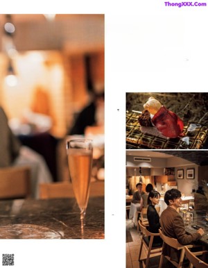 A woman eating a piece of pizza while sitting at a table.